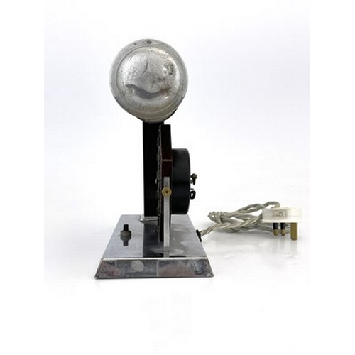 170 - An Art Deco chrome and bakelite desk lamp clock, circa 1930, the octagonal face with applied Arabic ... 