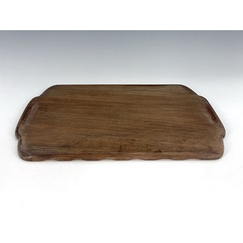 176 - Stanley Webb Davies, an Arts and Crafts carved walnut tray, 1941, rectangular form with serpentine r... 