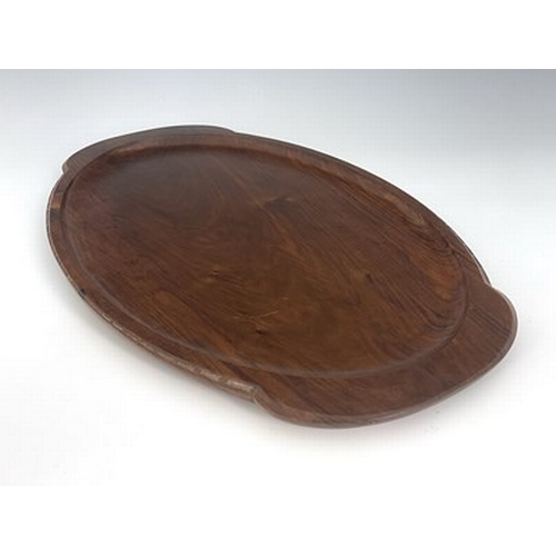 177 - Stanley Webb Davies, an Arts and Crafts carved walnut tray, 1945, twin handled oval form, with chain... 