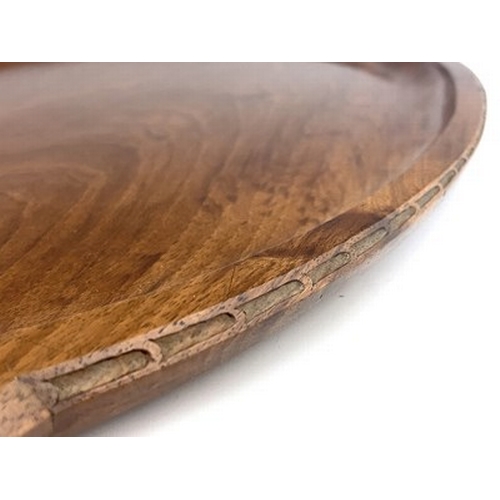 177 - Stanley Webb Davies, an Arts and Crafts carved walnut tray, 1945, twin handled oval form, with chain... 