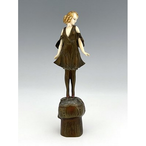 184 - Otto Poertzel, an Art Deco patinated bronze and ivory figure, circa 1925, modelled as a woman standi... 