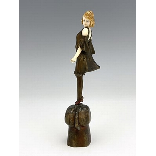 184 - Otto Poertzel, an Art Deco patinated bronze and ivory figure, circa 1925, modelled as a woman standi... 