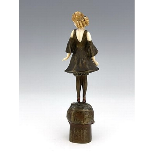 184 - Otto Poertzel, an Art Deco patinated bronze and ivory figure, circa 1925, modelled as a woman standi... 