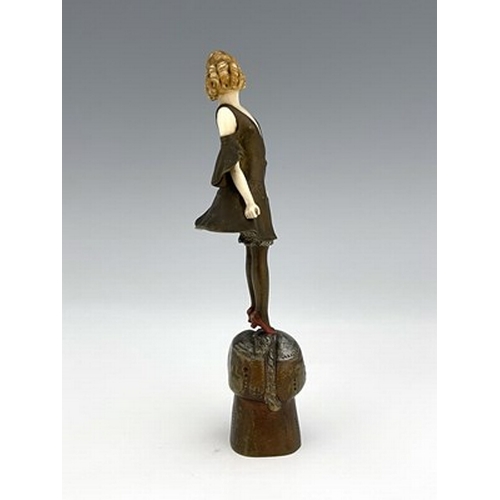 184 - Otto Poertzel, an Art Deco patinated bronze and ivory figure, circa 1925, modelled as a woman standi... 