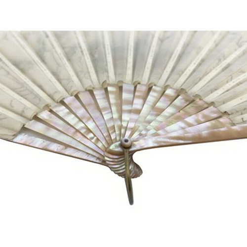 245 - An early 20th century Continental fan with mother of pearl sticks, the guards piqué with silver and ... 