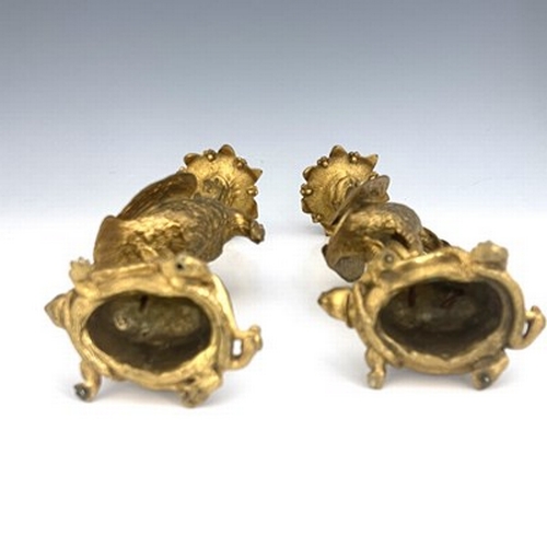 246 - A pair of George IV gilt bronze ormolu figural candlesticks, circa 1830, modelled as herons with fis... 