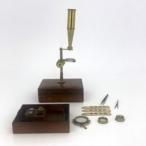 254 - An early 19th century gilt brass travelling microscope, in walnut case, various attachments and lens... 