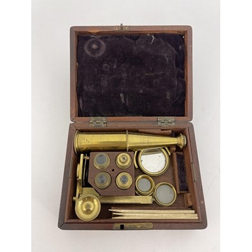 254 - An early 19th century gilt brass travelling microscope, in walnut case, various attachments and lens... 