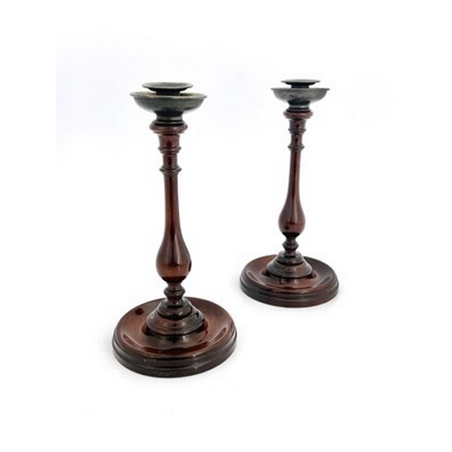 266 - A pair of George III mahogany candlesticks, circa 1800, slender turned baluster form on dished circu... 