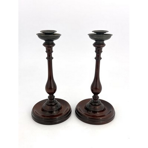 266 - A pair of George III mahogany candlesticks, circa 1800, slender turned baluster form on dished circu... 