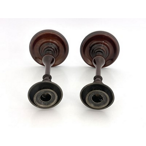 266 - A pair of George III mahogany candlesticks, circa 1800, slender turned baluster form on dished circu... 