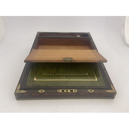 276 - A George III flame mahogany campaign writing slope, circa 1820, brass-bound with a triple strung bor... 