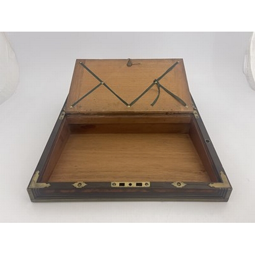 276 - A George III flame mahogany campaign writing slope, circa 1820, brass-bound with a triple strung bor... 