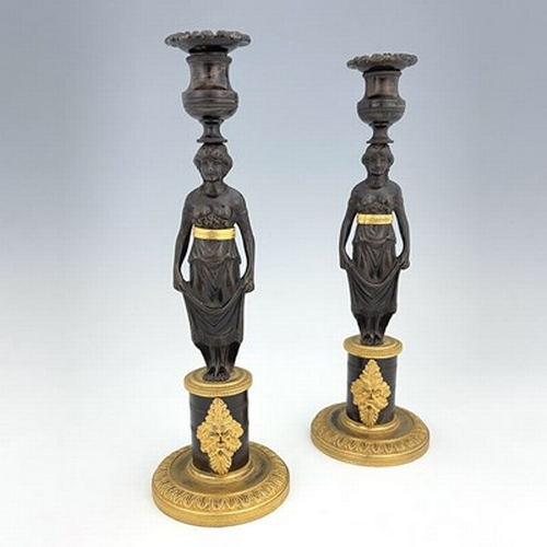 288 - A pair of Empire bronze and ormolu figural candlesticks, French circa 1815, the caryatid figures sup... 