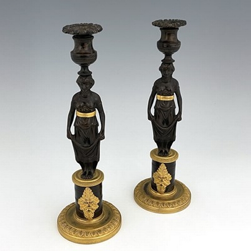 288 - A pair of Empire bronze and ormolu figural candlesticks, French circa 1815, the caryatid figures sup... 