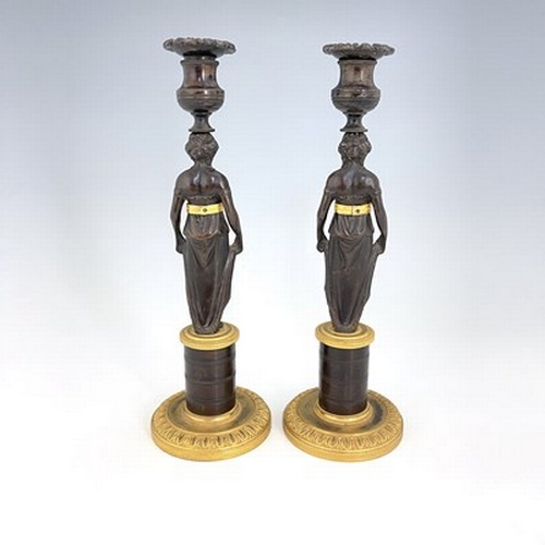 288 - A pair of Empire bronze and ormolu figural candlesticks, French circa 1815, the caryatid figures sup... 