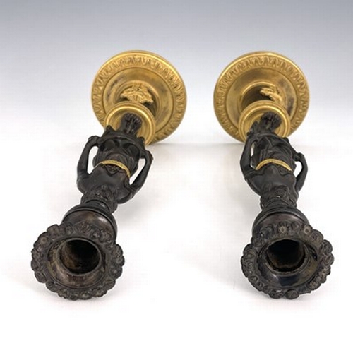 288 - A pair of Empire bronze and ormolu figural candlesticks, French circa 1815, the caryatid figures sup... 