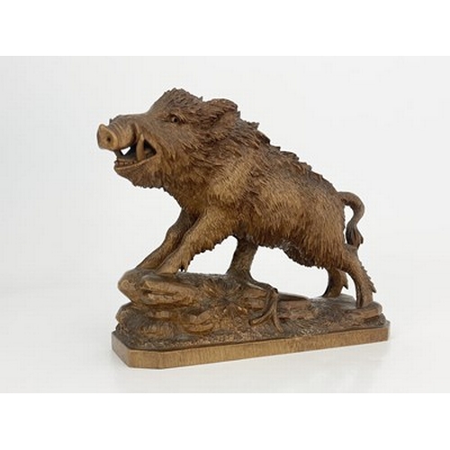 298 - A Black Forest carved wood figure of a boar, 19th century, realistically modelled on a rocky outcrop... 