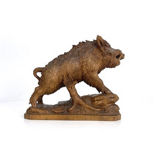 298 - A Black Forest carved wood figure of a boar, 19th century, realistically modelled on a rocky outcrop... 