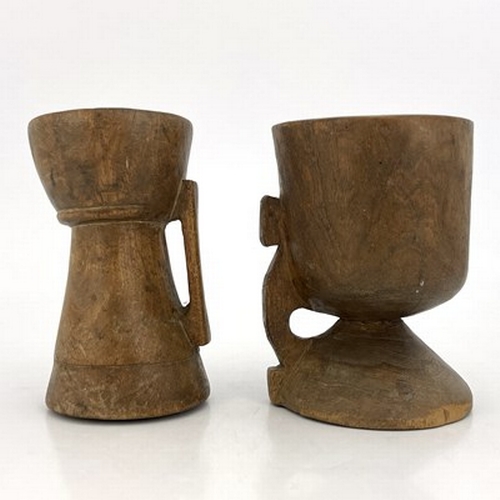 300 - Two monastic drinking vessels, carved and turned fruitwood, each of handled chalice form, on conical... 