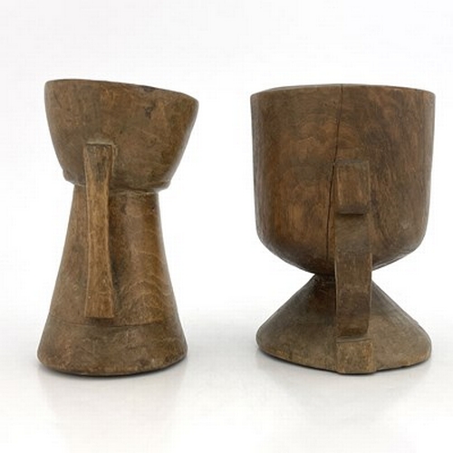 300 - Two monastic drinking vessels, carved and turned fruitwood, each of handled chalice form, on conical... 