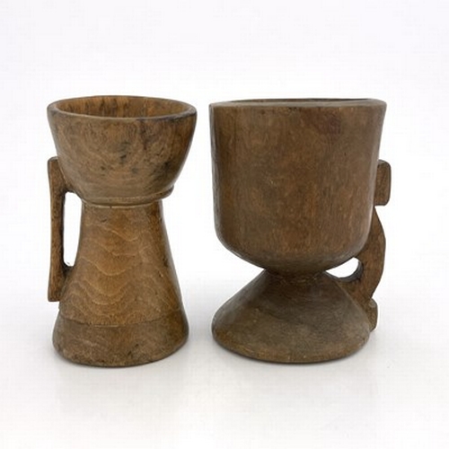 300 - Two monastic drinking vessels, carved and turned fruitwood, each of handled chalice form, on conical... 