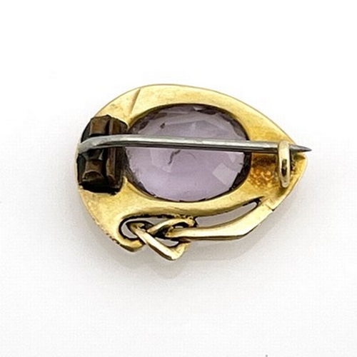 40 - Archibald Knox for Liberty and Co. an Arts and Crafts gold and amethyst brooch, model 1287, circa 19... 