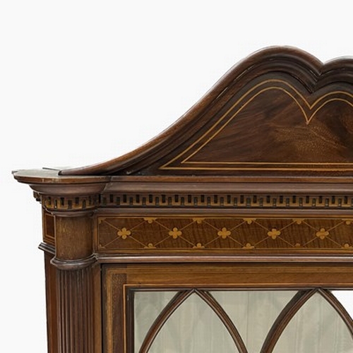 506 - An Edwardian mahogany corner standing vitrine, circa 1910, arched pediment, crossbanded, marquetry i... 