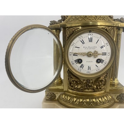 543 - Eug Bagues, Paris, a late 19th Century gilt metal bracket clock, of Baroque design with an urn of fr... 