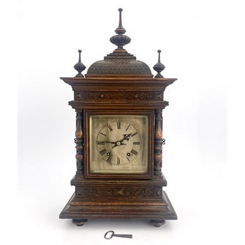 546 - A Black Forest oak bracket clock, late 19th Century, of Germanic architectural form with finials, do... 