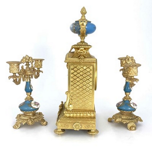 549 - A French porcelain and ormolu mounted clock garniture, circa 1885, the chiming clock movement stampe... 