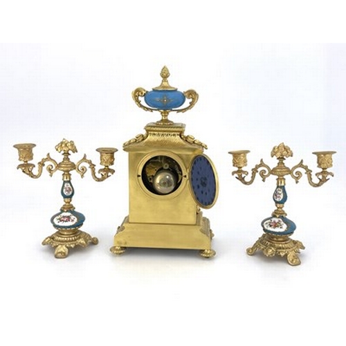 549 - A French porcelain and ormolu mounted clock garniture, circa 1885, the chiming clock movement stampe... 