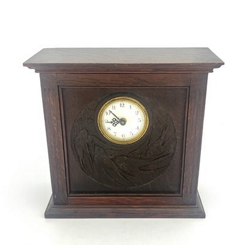 552 - An Arts and Crafts Glasgow School carved oak clock, cuboid form with fluted columns flanking a relie... 