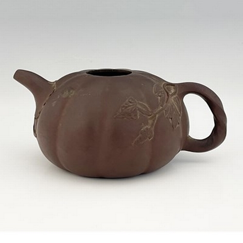 556 - A Chinese Yixing gourd teapot, lobed melon form with relief moulded leafy tendril and handle, 17cm l... 