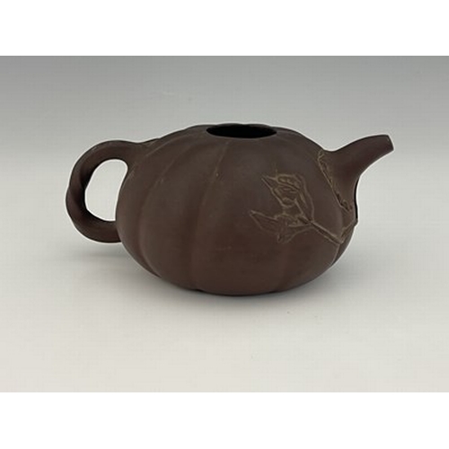 556 - A Chinese Yixing gourd teapot, lobed melon form with relief moulded leafy tendril and handle, 17cm l... 