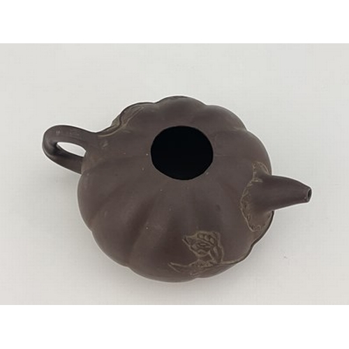 556 - A Chinese Yixing gourd teapot, lobed melon form with relief moulded leafy tendril and handle, 17cm l... 