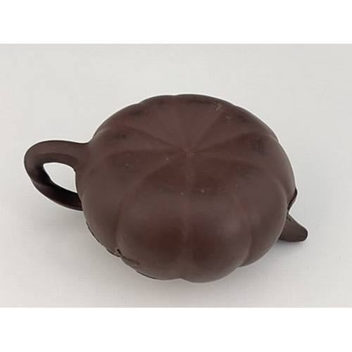 556 - A Chinese Yixing gourd teapot, lobed melon form with relief moulded leafy tendril and handle, 17cm l... 