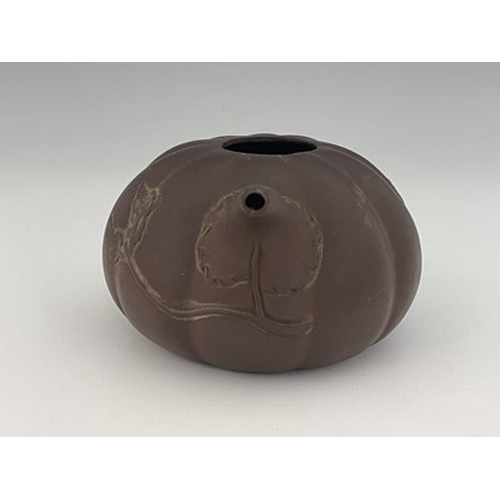 556 - A Chinese Yixing gourd teapot, lobed melon form with relief moulded leafy tendril and handle, 17cm l... 