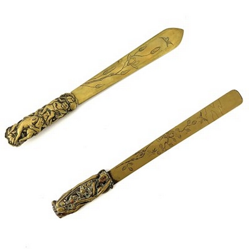 566 - Two Japanese brass and mixed metal page turners, the blades engraved with naturalistic floral branch... 