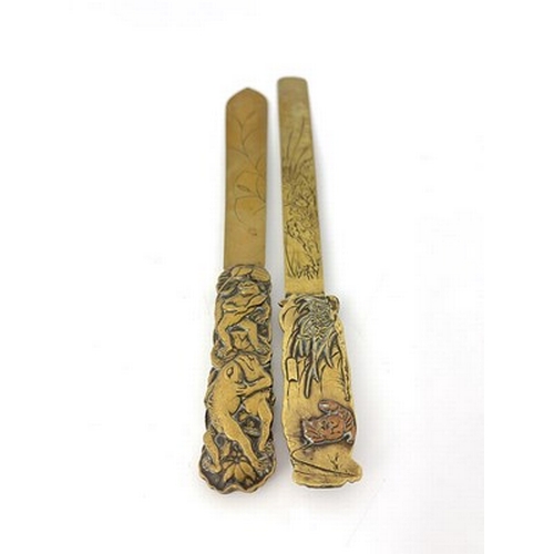 566 - Two Japanese brass and mixed metal page turners, the blades engraved with naturalistic floral branch... 