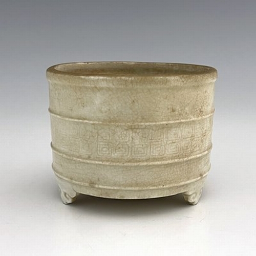 576 - A Chinese celadon glazed brush pot, cylindrical form with moulded rings, the central band with archa... 