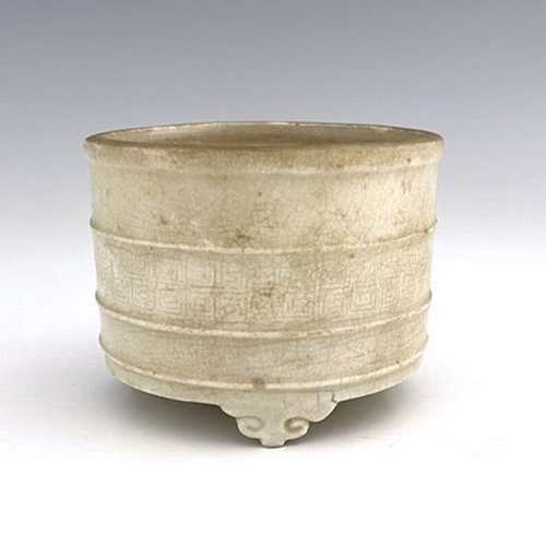 576 - A Chinese celadon glazed brush pot, cylindrical form with moulded rings, the central band with archa... 