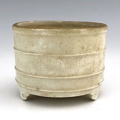 576 - A Chinese celadon glazed brush pot, cylindrical form with moulded rings, the central band with archa... 