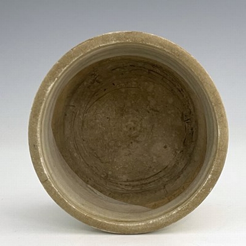 576 - A Chinese celadon glazed brush pot, cylindrical form with moulded rings, the central band with archa... 