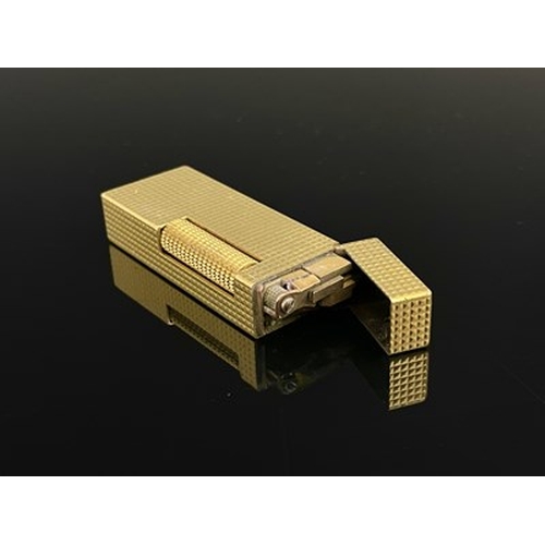 58 - A Dunhill gold plated rollagas lighter, hobnail decoration, in original case with paperwork