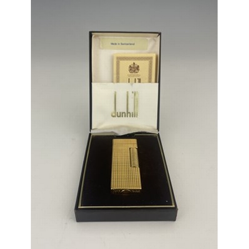 58 - A Dunhill gold plated rollagas lighter, hobnail decoration, in original case with paperwork