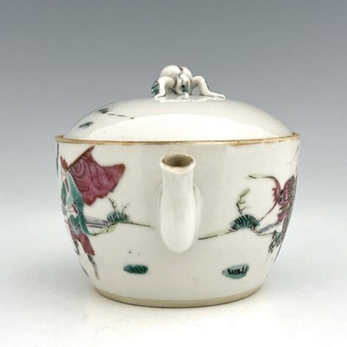 580 - A Chinese famille rose teapot and cover, of small proportions, painted with a deity riding a shishi,... 