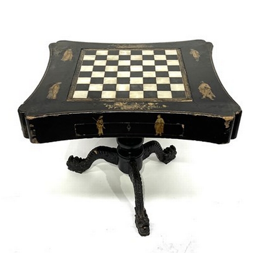 581 - A Chinese black lacquered and gilt games table, Qing Dynasty, inverted top decorated with gilt figur... 