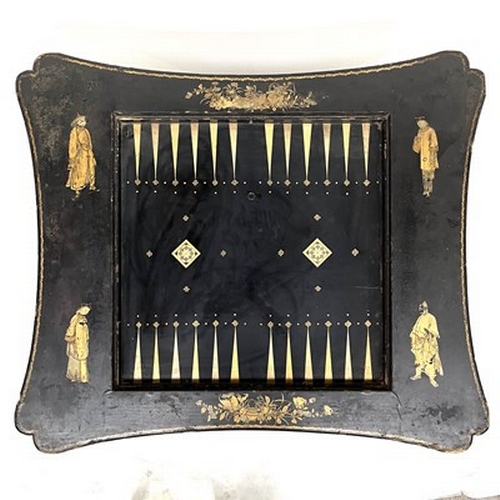 581 - A Chinese black lacquered and gilt games table, Qing Dynasty, inverted top decorated with gilt figur... 