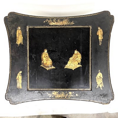 581 - A Chinese black lacquered and gilt games table, Qing Dynasty, inverted top decorated with gilt figur... 